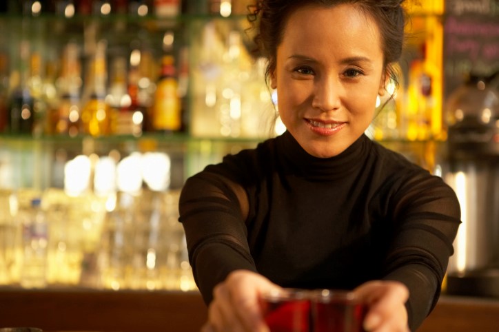 beverage events female bartender serving drinks at bar